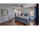 Primary bedroom featuring a ceiling fan, hardwood floors, and barn door to the bathroom at 452 Springfield Dr, Woodstock, GA 30188