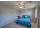 Cozy bedroom featuring plush carpet, ceiling fan, and a full size bed with bright blue patterned bedding at 452 Springfield Dr, Woodstock, GA 30188