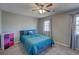 Cozy bedroom featuring plush carpet, ceiling fan, and a full size bed with bright blue patterned bedding at 452 Springfield Dr, Woodstock, GA 30188