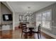 Dining room featuring a glass table, hardwood floors, and a modern light fixture at 452 Springfield Dr, Woodstock, GA 30188