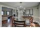 Bright dining room featuring a glass table, hardwood floors and a modern light fixture at 452 Springfield Dr, Woodstock, GA 30188