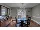 Elegant dining room features a modern light fixture, glass-top table, and a stylish sideboard for sophisticated dining at 452 Springfield Dr, Woodstock, GA 30188