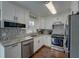 Modern kitchen featuring stainless steel appliances, granite countertops, and white cabinetry at 452 Springfield Dr, Woodstock, GA 30188