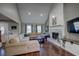 Bright living room with vaulted ceilings, a stone fireplace, and hardwood floors offer a cozy and stylish space at 452 Springfield Dr, Woodstock, GA 30188