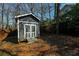 Backyard outbuilding provides extra storage space and complements the property's landscape at 452 Springfield Dr, Woodstock, GA 30188