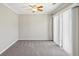 Carpeted room featuring neutral paint, a ceiling fan, and sliding doors to the exterior at 543 Harbor Lake Ct, Marietta, GA 30066
