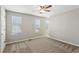 Spacious carpeted room featuring neutral paint and three bright windows with blinds at 543 Harbor Lake Ct, Marietta, GA 30066