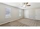 Carpeted bedroom featuring two windows letting in natural light, neutral walls, and two entry doors at 543 Harbor Lake Ct, Marietta, GA 30066