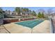 Community pool with a cover, surrounded by fencing and trees in a quiet setting at 543 Harbor Lake Ct, Marietta, GA 30066