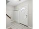 Bright front entry featuring tiled floors, coat storage, and a white front door with window at 543 Harbor Lake Ct, Marietta, GA 30066