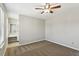 Spacious bedroom features neutral carpet, ceiling fan and ensuite bath with large vanity and mirror at 543 Harbor Lake Ct, Marietta, GA 30066