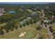 Aerial view of community featuring tennis courts, a lake, a golf course, and a swimming pool at 6525 Oak Highlands Ct, Cumming, GA 30041
