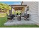 Cozy back patio featuring comfortable seating and an outdoor fireplace at 6525 Oak Highlands Ct, Cumming, GA 30041