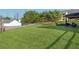 Expansive backyard with lush green lawn, a split rail fence, and mature trees at 6525 Oak Highlands Ct, Cumming, GA 30041