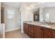 Bathroom featuring double sinks with granite counters, a window and a doorway to the shower at 6525 Oak Highlands Ct, Cumming, GA 30041