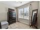 Bedroom with a dresser, mirror, stool, window with curtains and carpet at 6525 Oak Highlands Ct, Cumming, GA 30041