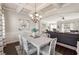 Elegant dining room with coffered ceilings, wainscoting, and an open view to the living area at 6525 Oak Highlands Ct, Cumming, GA 30041