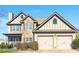 Charming two-story home featuring a stone facade, attached two-car garage, and meticulously maintained landscaping at 6525 Oak Highlands Ct, Cumming, GA 30041