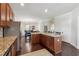 Kitchen with wood cabinets, stainless steel appliances, granite countertops, breakfast bar, and wood floors at 6525 Oak Highlands Ct, Cumming, GA 30041