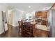 Modern kitchen with wood cabinets, stainless steel appliances, granite countertops, and a breakfast bar with chairs at 6525 Oak Highlands Ct, Cumming, GA 30041