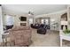 Spacious living room featuring plush carpeting, a stone fireplace, and ample seating perfect for entertaining at 6525 Oak Highlands Ct, Cumming, GA 30041