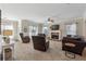 Bright living room boasts neutral tones, a cozy fireplace, and multiple seating arrangements for relaxation and socializing at 6525 Oak Highlands Ct, Cumming, GA 30041