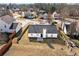 Overhead shot of a charming home, set within a serene neighborhood surrounded by mature trees at 6800 Bells Landing Way, Rex, GA 30273