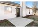 A concrete slab and black door on a house exterior, surrounded by grass at 6800 Bells Landing Way, Rex, GA 30273