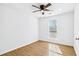 Bright bedroom with ceiling fan, hardwood floors, and a window at 6800 Bells Landing Way, Rex, GA 30273