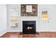 A cozy fireplace with black tile, a white mantel and a stone facade at 6800 Bells Landing Way, Rex, GA 30273