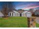 Charming single-story home with a well-manicured lawn, inviting curb appeal, and neutral exterior paint at 6800 Bells Landing Way, Rex, GA 30273