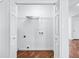Bright, empty laundry room with wood-look floors at 6800 Bells Landing Way, Rex, GA 30273