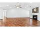 A light and airy living space with hardwood floors, a fireplace, and modern lighting at 6800 Bells Landing Way, Rex, GA 30273