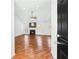 Open floor plan showcasing living room with fireplace and wood floors at 6800 Bells Landing Way, Rex, GA 30273