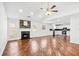 Spacious open floorplan with a fireplace, hardwood floors, and a combined kitchen area at 6800 Bells Landing Way, Rex, GA 30273