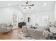 Primary suite featuring a vaulted ceiling, wood look floors, sitting area, and ensuite bathroom at 6800 Bells Landing Way, Rex, GA 30273