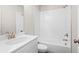 Well-lit bathroom featuring a bathtub with white subway tile surround, a sink, and gold fixtures at 1929 Quarry Park Nw Pl, Atlanta, GA 30318