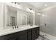 Modern bathroom featuring double sinks, a large mirror, and a glass-enclosed shower at 1929 Quarry Park Nw Pl, Atlanta, GA 30318