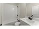 Bathroom featuring tiled shower and tub, toilet, and a white vanity with dark hardware at 1929 Quarry Park Nw Pl, Atlanta, GA 30318