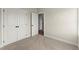 Bedroom featuring a spacious closet, light-colored carpet, and an open doorway to the rest of the home at 1929 Quarry Park Nw Pl, Atlanta, GA 30318