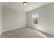 Sunlit bedroom featuring neutral walls and carpet along with a large window for a relaxing atmosphere at 1929 Quarry Park Nw Pl, Atlanta, GA 30318