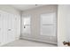 Bedroom with neutral carpet, base trim, and window at 1929 Quarry Park Nw Pl, Atlanta, GA 30318