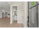 Inviting entryway with light wood floors, leading to an open-concept kitchen and bathroom at 1929 Quarry Park Nw Pl, Atlanta, GA 30318