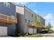 Townhomes featuring grey siding and a wooden deck over a one car garage at 1929 Quarry Park Nw Pl, Atlanta, GA 30318
