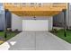 Back of home featuring a concrete driveway and a white one-car garage under wooden deck at 1929 Quarry Park Nw Pl, Atlanta, GA 30318