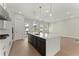 Stylish kitchen with a large island, marble countertops, pendant lighting, and stainless steel appliances at 1929 Quarry Park Nw Pl, Atlanta, GA 30318