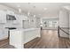 Modern kitchen with stainless steel appliances, white cabinets, island, and hardwood floors opening to the living space at 1929 Quarry Park Nw Pl, Atlanta, GA 30318