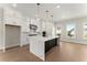 Modern kitchen featuring a large island with marble countertops and white cabinetry at 1929 Quarry Park Nw Pl, Atlanta, GA 30318