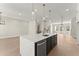 Open kitchen with marble island, stainless steel appliances, and views of staircase at 1929 Quarry Park Nw Pl, Atlanta, GA 30318