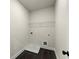 Functional laundry room with tile flooring and utility connections at 1929 Quarry Park Nw Pl, Atlanta, GA 30318